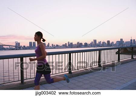 Young Japanese woman running downtown Tokyo View Large Photo Image Stock Image - Young Japanese woman running downtown Tokyo. Fotosearch