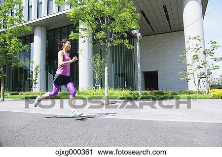 Young Japanese woman running downtown Tokyo View Large Photo Image Stock Image - Young Japanese woman running downtown Tokyo. Fotosearch