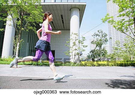 Young Japanese woman running downtown Tokyo View Large Photo Image Stock Image - Young Japanese woman running downtown Tokyo. Fotosearch