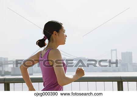 Young Japanese woman running downtown Tokyo View Large Photo Image Stock Image - Young Japanese woman running downtown Tokyo. Fotosearch