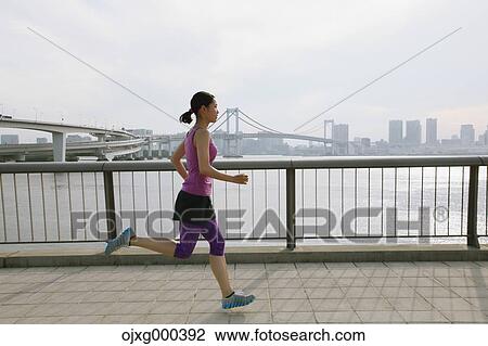 Young Japanese woman running downtown Tokyo View Large Photo Image Stock Image - Young Japanese woman running downtown Tokyo. Fotosearch