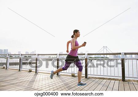 Young Japanese woman running downtown Tokyo View Large Photo Image Stock Image - Young Japanese woman running downtown Tokyo. Fotosearch