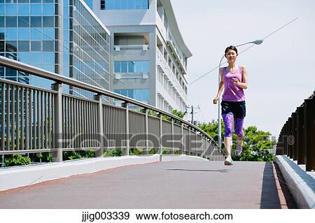 Young Japanese woman running downtown Tokyo View Large Photo Image Stock Photo - Young Japanese woman running downtown Tokyo. Fotosearch
