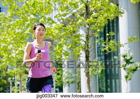Young Japanese woman running downtown Tokyo View Large Photo Image Stock Photo - Young Japanese woman running downtown Tokyo. Fotosearch
