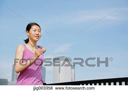 Young Japanese woman running downtown Tokyo View Large Photo Image Stock Photo - Young Japanese woman running downtown Tokyo. Fotosearch