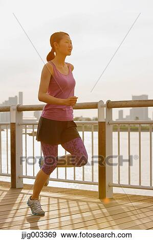 Young Japanese woman running downtown Tokyo View Large Photo Image Stock Photo - Young Japanese woman running downtown Tokyo. Fotosearch