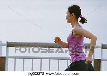 Young Japanese woman running downtown Tokyo View Large Photo Image Stock Photo - Young Japanese woman running downtown Tokyo. Fotosearch
