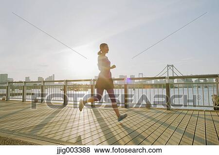 Young Japanese woman running downtown Tokyo View Large Photo Image Stock Photo - Young Japanese woman running downtown Tokyo. Fotosearch