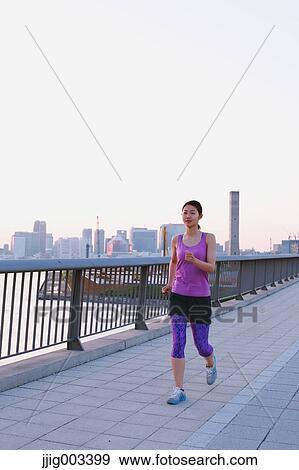 Young Japanese woman running downtown Tokyo View Large Photo Image Stock Photo - Young Japanese woman running downtown Tokyo. Fotosearch