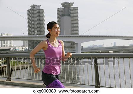 Young Japanese woman running downtown Tokyo View Large Photo Image Stock Photo - Young Japanese woman running downtown Tokyo. Fotosearch