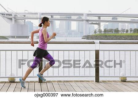 Young Japanese woman running downtown Tokyo View Large Photo Image Stock Photo - Young Japanese woman running downtown Tokyo. Fotosearch