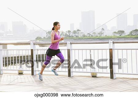 Young Japanese woman running downtown Tokyo View Large Photo Image Stock Photo - Young Japanese woman running downtown Tokyo. Fotosearch