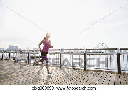 Young Japanese woman running downtown Tokyo View Large Photo Image Stock Photo - Young Japanese woman running downtown Tokyo. Fotosearch