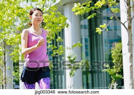 Young Japanese woman running downtown Tokyo View Large Photo Image Stock Photograph - Young Japanese woman running downtown Tokyo. Fotosearch