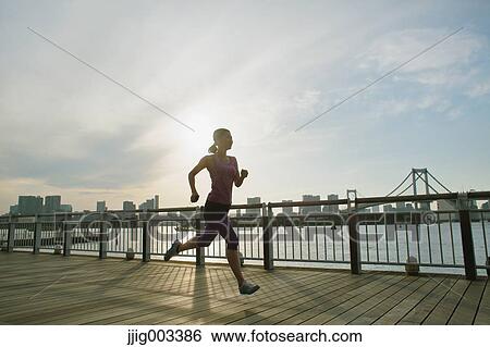 Young Japanese woman running downtown Tokyo View Large Photo Image Stock Photograph - Young Japanese woman running downtown Tokyo. Fotosearch