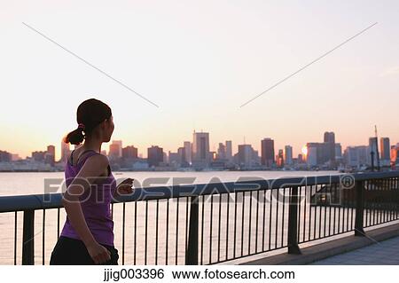 Young Japanese woman running downtown Tokyo View Large Photo Image Stock Photograph - Young Japanese woman running downtown Tokyo. Fotosearch