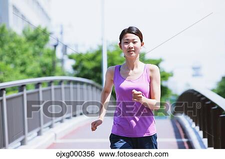 Young Japanese woman running downtown Tokyo View Large Photo Image Stock Photograph - Young Japanese woman running downtown Tokyo. Fotosearch