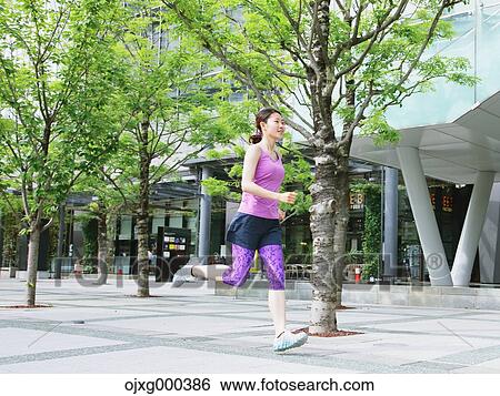 Young Japanese woman running downtown Tokyo View Large Photo Image Stock Photograph - Young Japanese woman running downtown Tokyo. Fotosearch