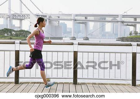 Young Japanese woman running downtown Tokyo View Large Photo Image Stock Photograph - Young Japanese woman running downtown Tokyo. Fotosearch