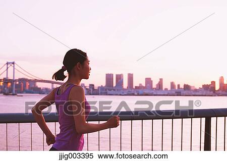 Young Japanese woman running downtown Tokyo View Large Photo Image Stock Photography - Young Japanese woman running downtown Tokyo. Fotosearch