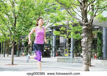 Young Japanese woman running downtown Tokyo View Large Photo Image Stock Photography - Young Japanese woman running downtown Tokyo. Fotosearch