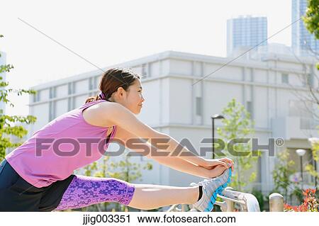 Young Japanese woman stretching before her run downtown Tokyo View Large Photo Image Stock Image - Young Japanese woman stretching before her run downtown Tokyo. Fotosearch