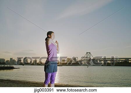 Young Japanese woman stretching before her run downtown Tokyo View Large Photo Image Stock Image - Young Japanese woman stretching before her run downtown Tokyo. Fotosearch