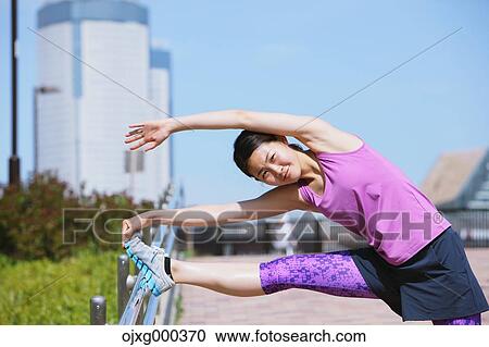 Young Japanese woman stretching before her run downtown Tokyo View Large Photo Image Stock Image - Young Japanese woman stretching before her run downtown Tokyo. Fotosearch