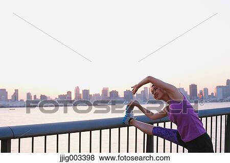 Young Japanese woman stretching before her run downtown Tokyo View Large Photo Image Stock Photo - Young Japanese woman stretching before her run downtown Tokyo. Fotosearch