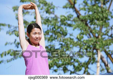 Young Japanese woman stretching before her run downtown Tokyo View Large Photo Image Stock Photo - Young Japanese woman stretching before her run downtown Tokyo. Fotosearch