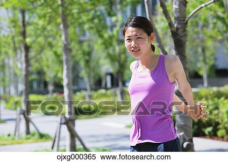 Young Japanese woman stretching before her run downtown Tokyo View Large Photo Image Stock Photography - Young Japanese woman stretching before her run downtown Tokyo. Fotosearch