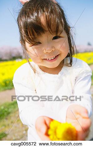 Young smiling Japanese girl enjoying cherry blossoms in a city park View Large Photo Image Stock Image - Young smiling Japanese girl enjoying cherry blossoms in a city park. Fotosearch