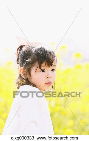 Young smiling Japanese girl enjoying cherry blossoms in a city park View Large Photo Image Stock Image - Young smiling Japanese girl enjoying cherry blossoms in a city park. Fotosearch