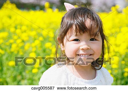 Young smiling Japanese girl enjoying cherry blossoms in a city park View Large Photo Image Stock Photo - Young smiling Japanese girl enjoying cherry blossoms in a city park. Fotosearch