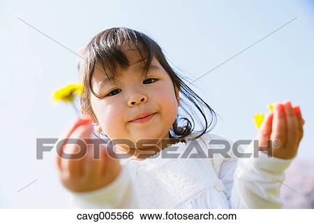 Young smiling Japanese girl enjoying cherry blossoms in a city park View Large Photo Image Stock Photograph - Young smiling Japanese girl enjoying cherry blossoms in a city park. Fotosearch