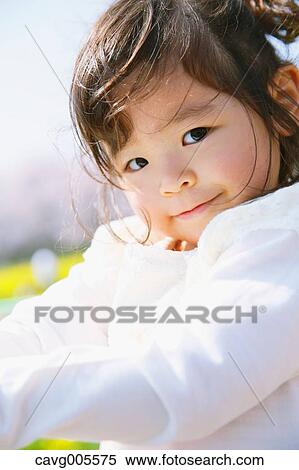Young smiling Japanese girl enjoying cherry blossoms in a city park View Large Photo Image Stock Photography - Young smiling Japanese girl enjoying cherry blossoms in a city park. Fotosearch