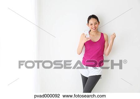 Attractive Japanese woman relaxing after training in a airy room View Large Photo Image Stock Image - Attractive Japanese woman relaxing after training in a airy room. Fotosearch