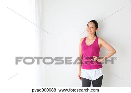 Attractive Japanese woman relaxing after training in a airy room View Large Photo Image Stock Photo - Attractive Japanese woman relaxing after training in a airy room. Fotosearch