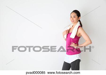 Attractive Japanese woman relaxing after training in a airy room View Large Photo Image Stock Photography - Attractive Japanese woman relaxing after training in a airy room. Fotosearch