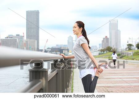 Attractive Japanese woman training by a river downtown Tokyo, Japan View Large Photo Image Stock Image - Attractive Japanese woman training by a river downtown Tokyo, Japan. Fotosearch