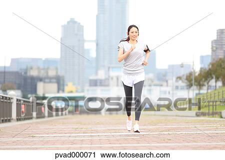 Attractive Japanese woman training by a river downtown Tokyo, Japan View Large Photo Image Stock Image - Attractive Japanese woman training by a river downtown Tokyo, Japan. Fotosearch