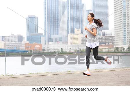Attractive Japanese woman training by a river downtown Tokyo, Japan View Large Photo Image Stock Image - Attractive Japanese woman training by a river downtown Tokyo, Japan. Fotosearch