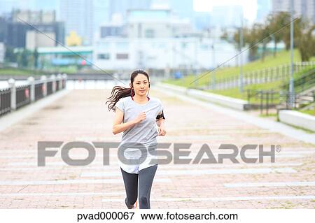 Attractive Japanese woman training by a river downtown Tokyo, Japan View Large Photo Image Stock Photo - Attractive Japanese woman training by a river downtown Tokyo, Japan. Fotosearch