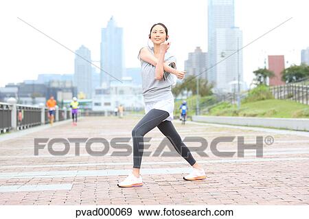 Attractive Japanese woman training by a river downtown Tokyo, Japan View Large Photo Image Stock Photo - Attractive Japanese woman training by a river downtown Tokyo, Japan. Fotosearch