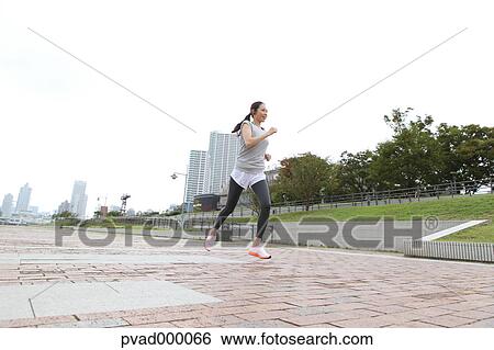 Attractive Japanese woman training by a river downtown Tokyo, Japan View Large Photo Image Stock Photograph - Attractive Japanese woman training by a river downtown Tokyo, Japan. Fotosearch
