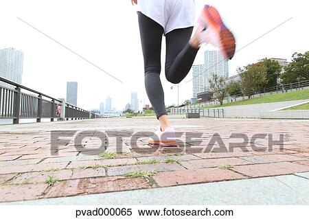 Attractive Japanese woman training by a river downtown Tokyo, Japan View Large Photo Image Stock Photography - Attractive Japanese woman training by a river downtown Tokyo, Japan. Fotosearch