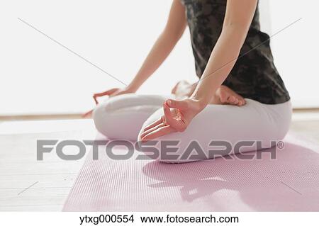 Attractive young Japanese practicing yoga in an airy room View Large Photo Image Picture - Attractive young Japanese practicing yoga in an airy room. Fotosearch