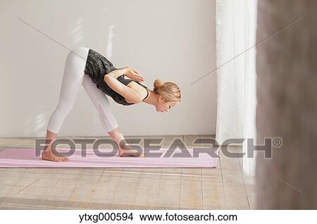Attractive young Japanese practicing yoga in an airy room View Large Photo Image Picture - Attractive young Japanese practicing yoga in an airy room. Fotosearch