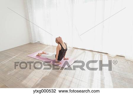 Attractive young Japanese practicing yoga in an airy room View Large Photo Image Stock Image - Attractive young Japanese practicing yoga in an airy room. Fotosearch