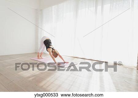 Attractive young Japanese practicing yoga in an airy room View Large Photo Image Stock Image - Attractive young Japanese practicing yoga in an airy room. Fotosearch